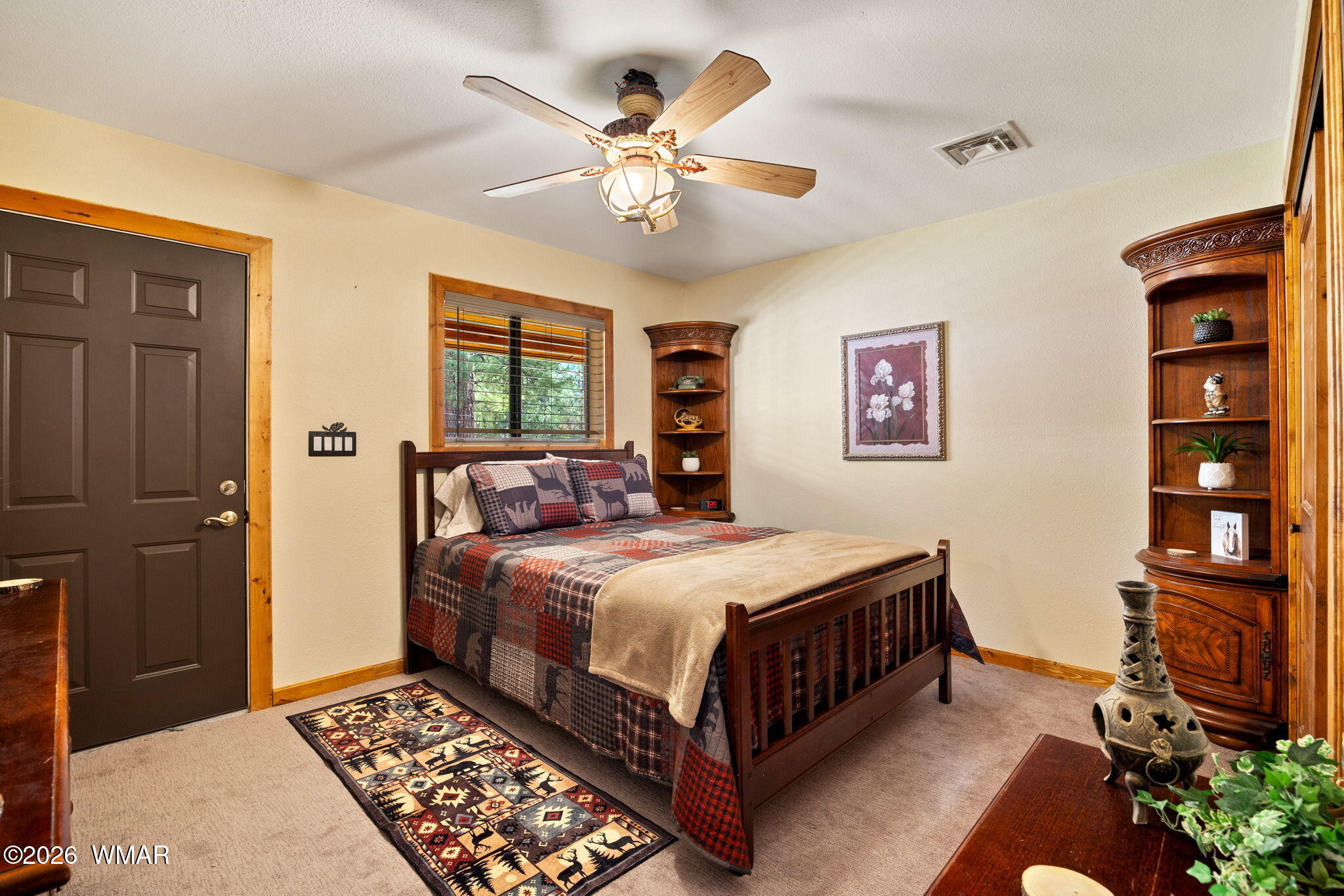 2924 Pine Rim Road Overgaard, AZ 85933 - Photo 19 of 43 a bedroom with a bed and a chandelier