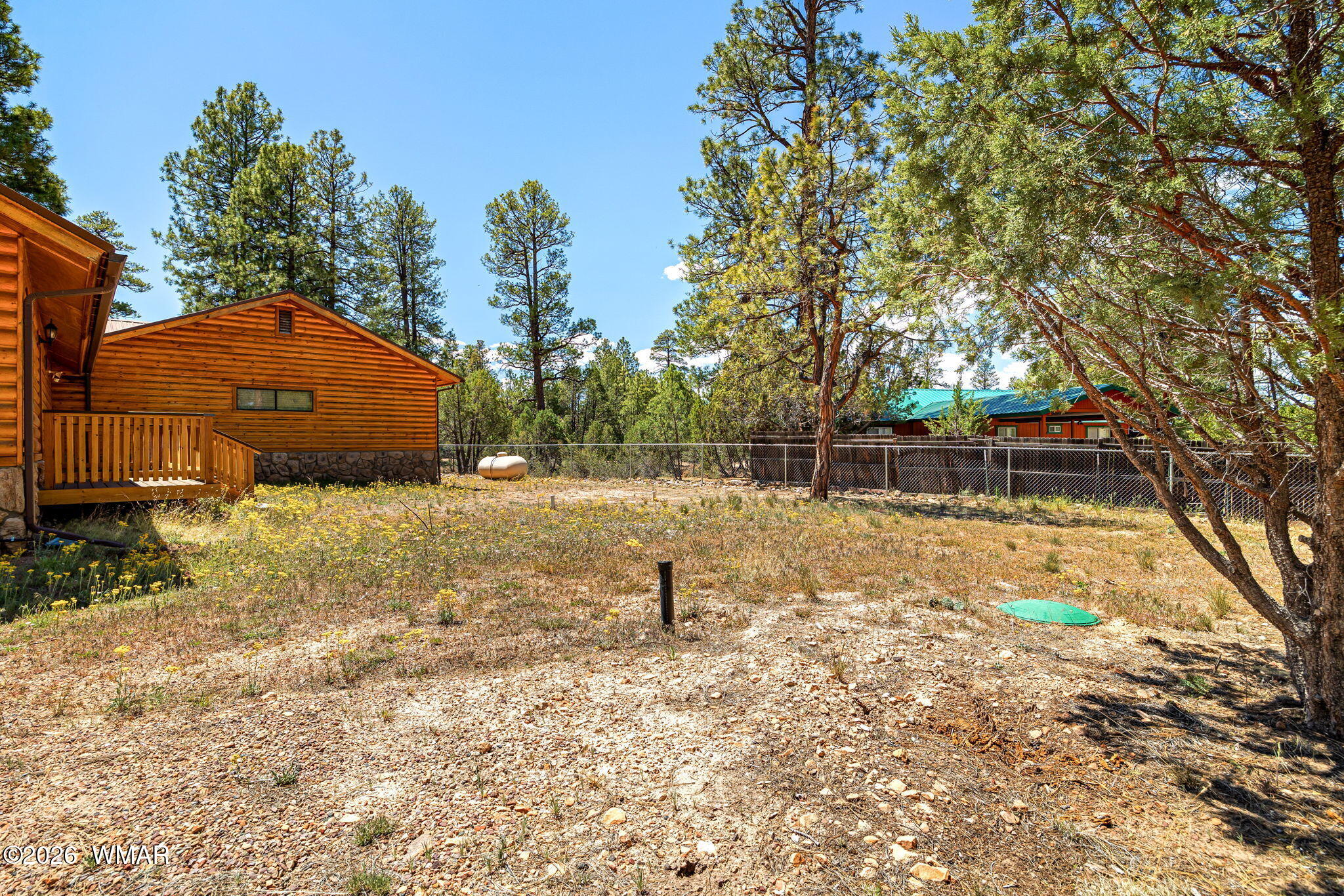 2924 Pine Rim Road Overgaard, AZ 85933 - Photo 32 of 43 a backyard of a house with a yard and outdoor seating