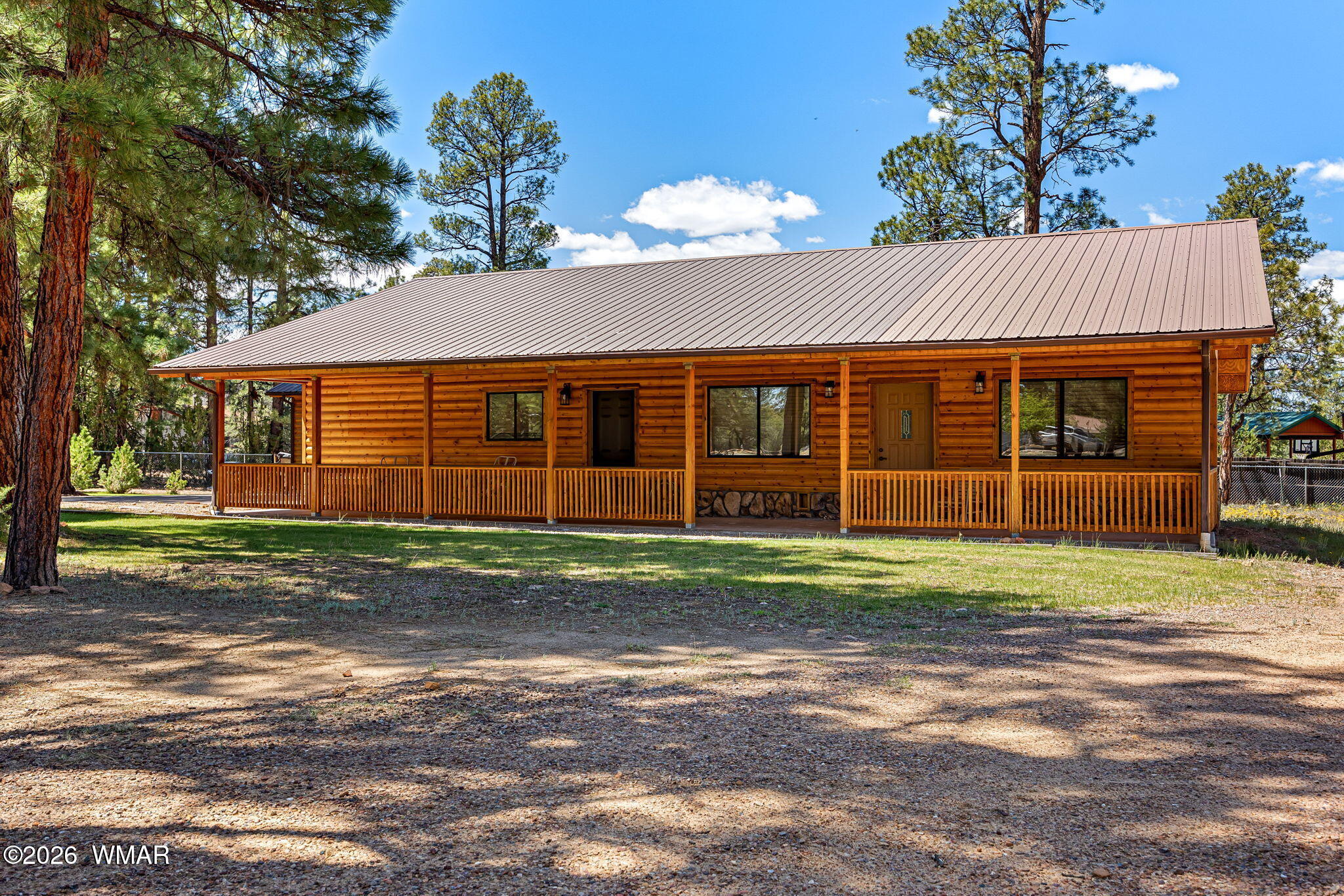 2924 Pine Rim Road Overgaard, AZ 85933 - Photo 3 of 43 a front view of a house with a garden