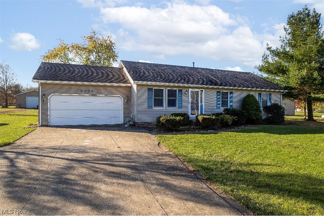 9066 Crow Road Litchfield, OH 44253 - Photo 2 of 28 Ranch-style home featuring a garage and a front lawn