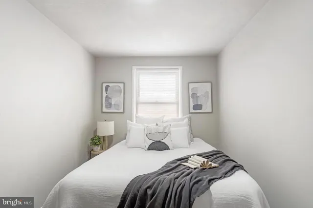 a bedroom with a bed and window