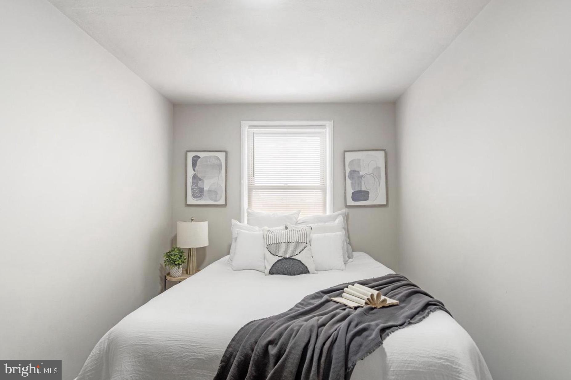 7509 Durwood Road Baltimore, MD 21222 - Photo 16 of 24 a bedroom with a bed and window