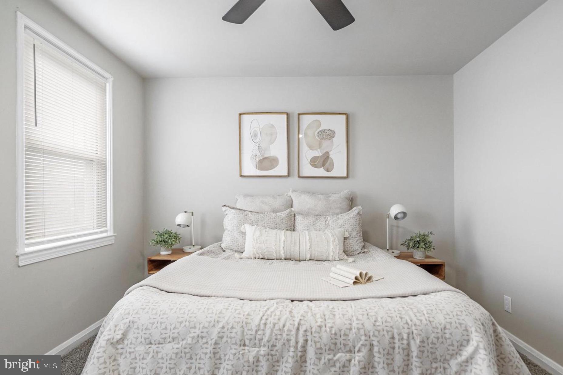 7509 Durwood Road Baltimore, MD 21222 - Photo 18 of 24 a bedroom with a bed and a window