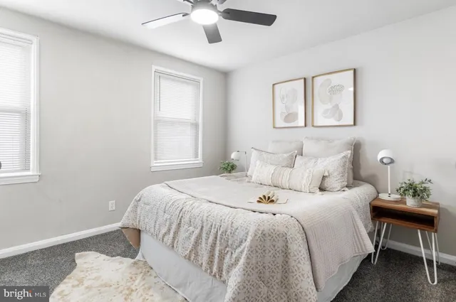 a bedroom with a large bed and a window