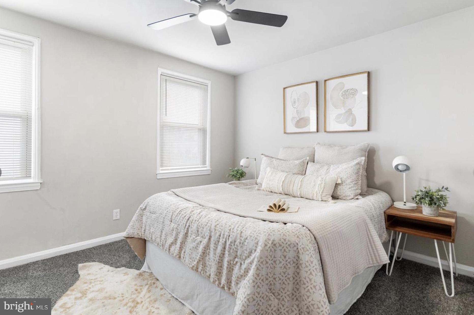 7509 Durwood Road Baltimore, MD 21222 - Photo 19 of 24 a bedroom with a large bed and a window