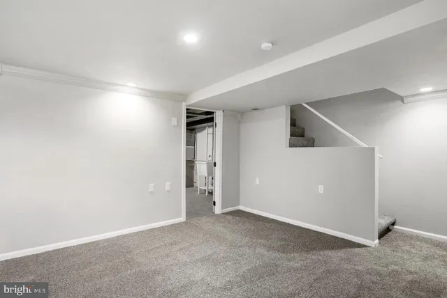 an empty room with windows & cabinet