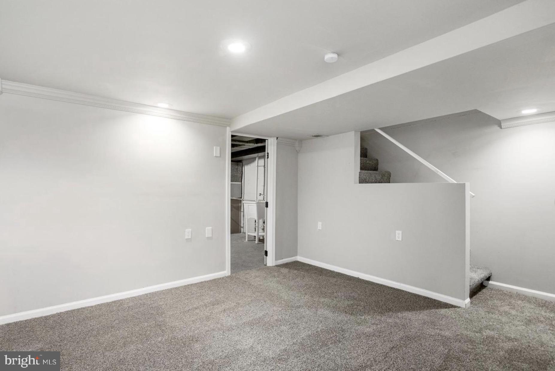 7509 Durwood Road Baltimore, MD 21222 - Photo 21 of 24 an empty room with windows & cabinet