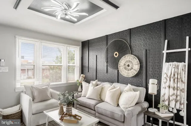 a living room with furniture a fireplace and a large window