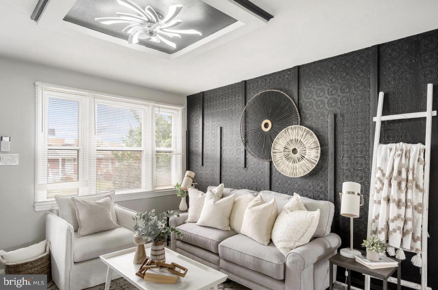 7509 Durwood Road Baltimore, MD 21222 - Photo 5 of 24 a living room with furniture a fireplace and a large window
