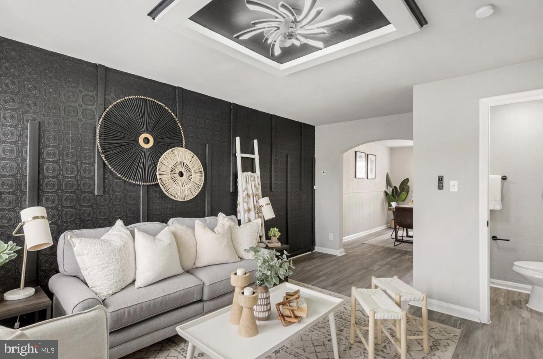 7509 Durwood Road Baltimore, MD 21222 - Photo 6 of 24 a living room with furniture and wooden floor