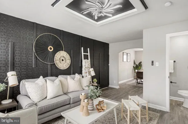 a living room with furniture and wooden floor