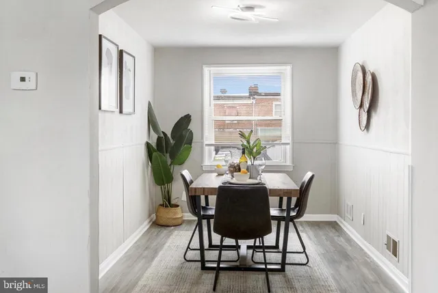 a view of a dining room with furniture and a potted plant