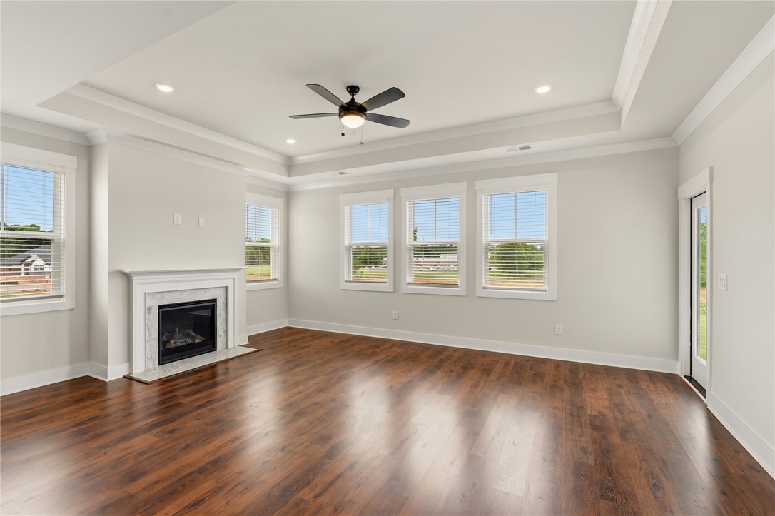 310 Bluestem Court Anderson, SC 29621 - Photo 18 of 36 This bright living space features rich laminate floors and an elegant fireplace, perfect for gatherings.