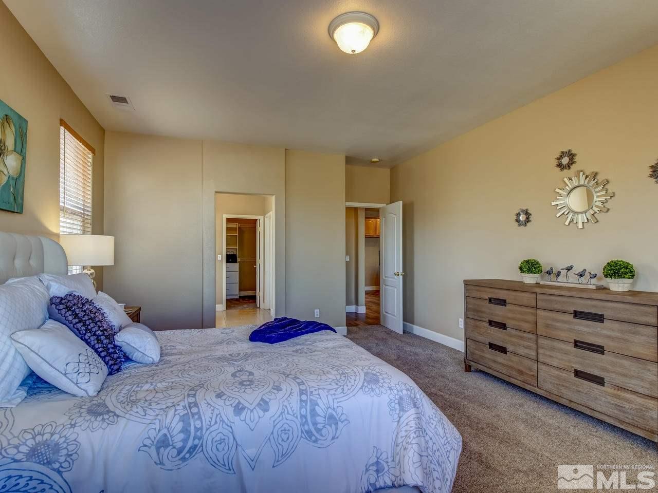 10803 Rushing Flume Drive Reno, NV 89521 - Photo 14 of 22 a bedroom with a bed and a lamp on dresser