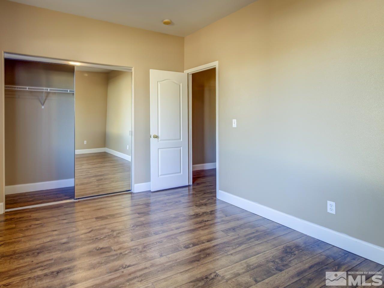 10803 Rushing Flume Drive Reno, NV 89521 - Photo 18 of 22 a view of an empty room with wooden floor and closet