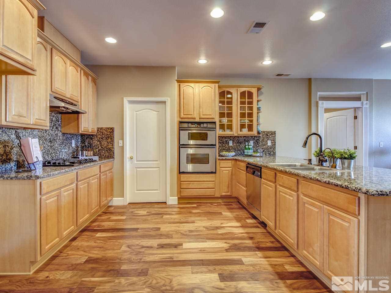 10803 Rushing Flume Drive Reno, NV 89521 - Photo 2 of 22 a large kitchen with kitchen island a sink stainless steel appliances and cabinets
