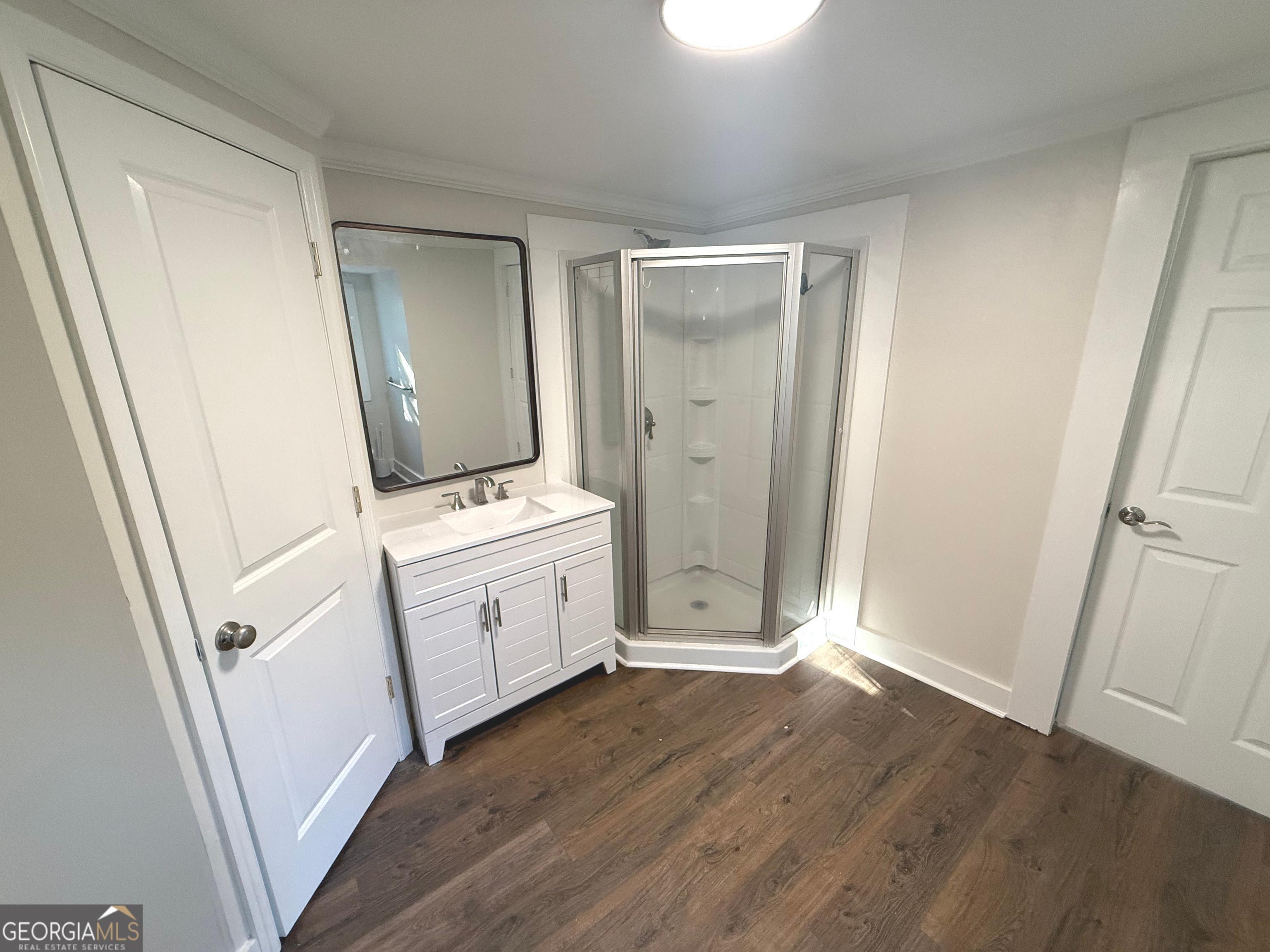 405 Monroe Street Garfield, GA 30425 - Photo 11 of 30 an empty room with wooden floor and white doors