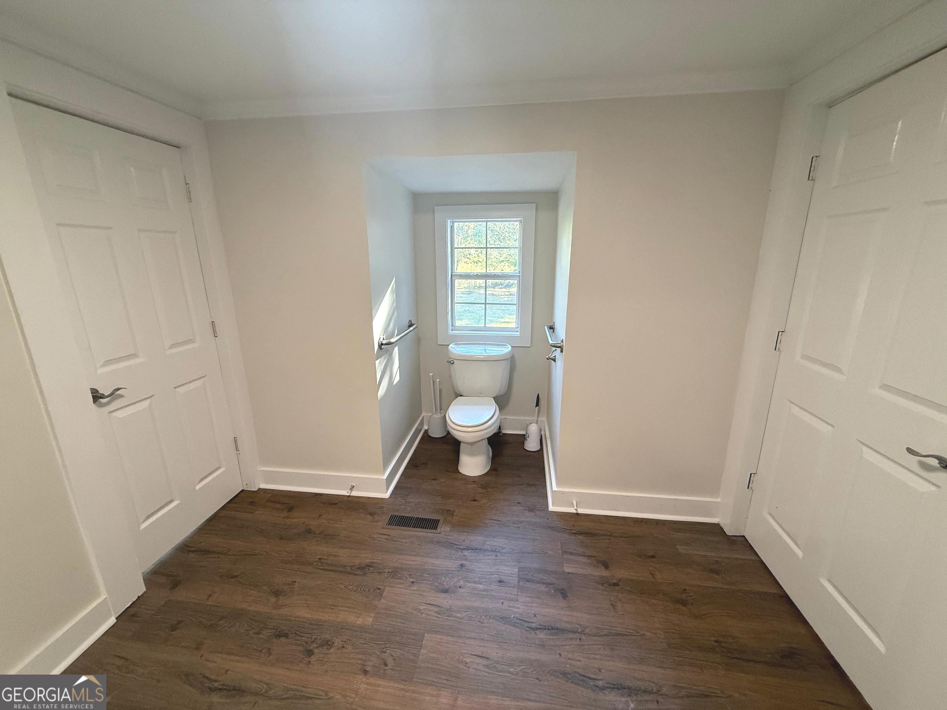 405 Monroe Street Garfield, GA 30425 - Photo 12 of 30 a view of an empty room and wooden floor