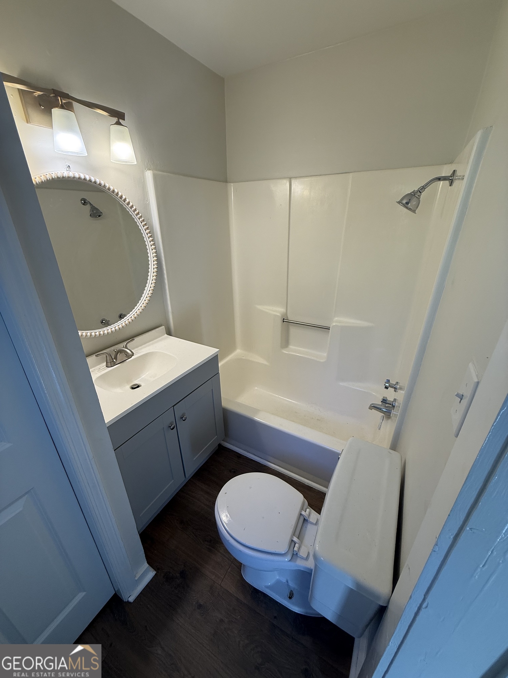 405 Monroe Street Garfield, GA 30425 - Photo 14 of 30 a bathroom with a sink mirror vanity and toilet