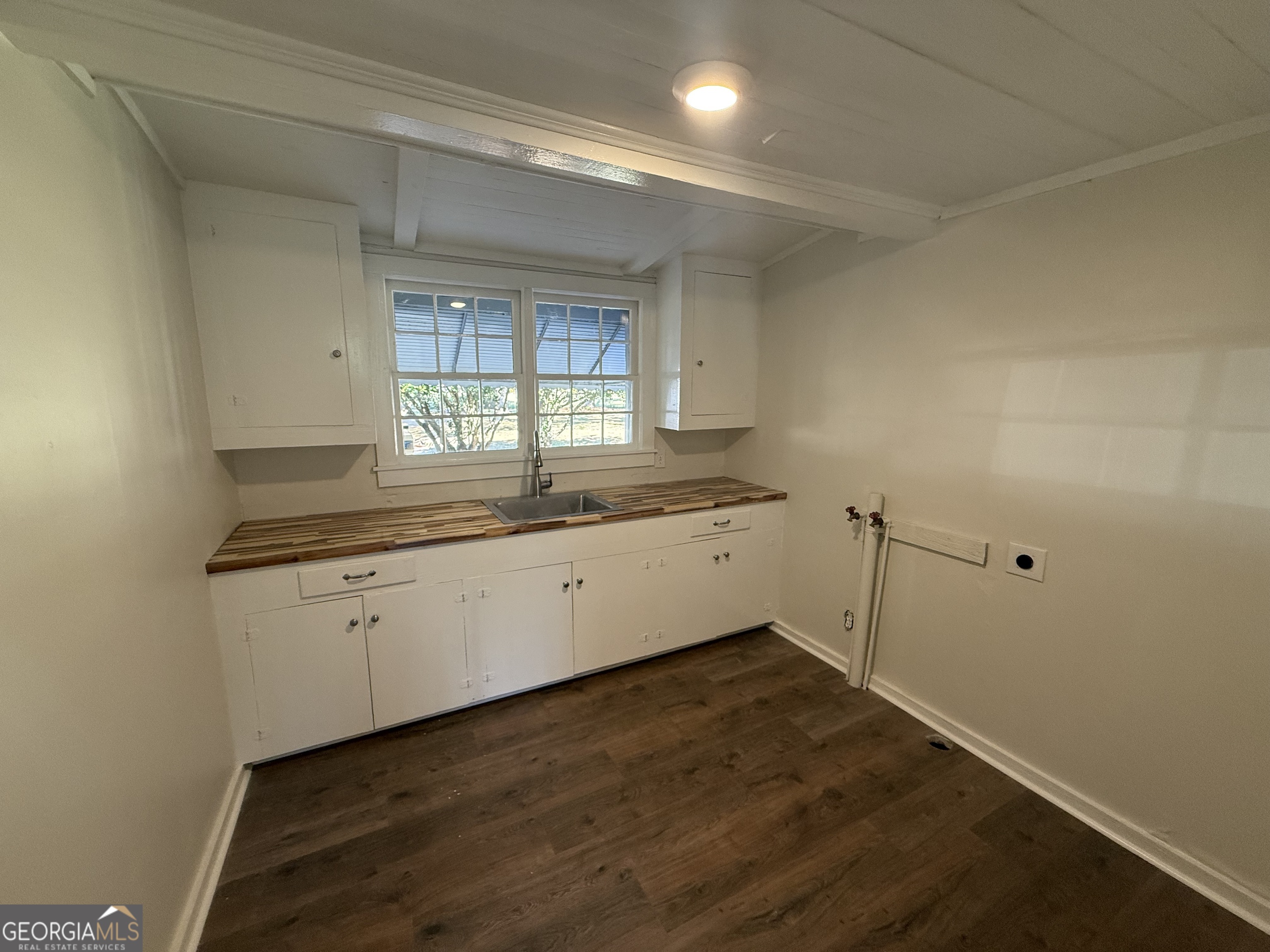 405 Monroe Street Garfield, GA 30425 - Photo 19 of 30 a kitchen with a sink cabinets and a window