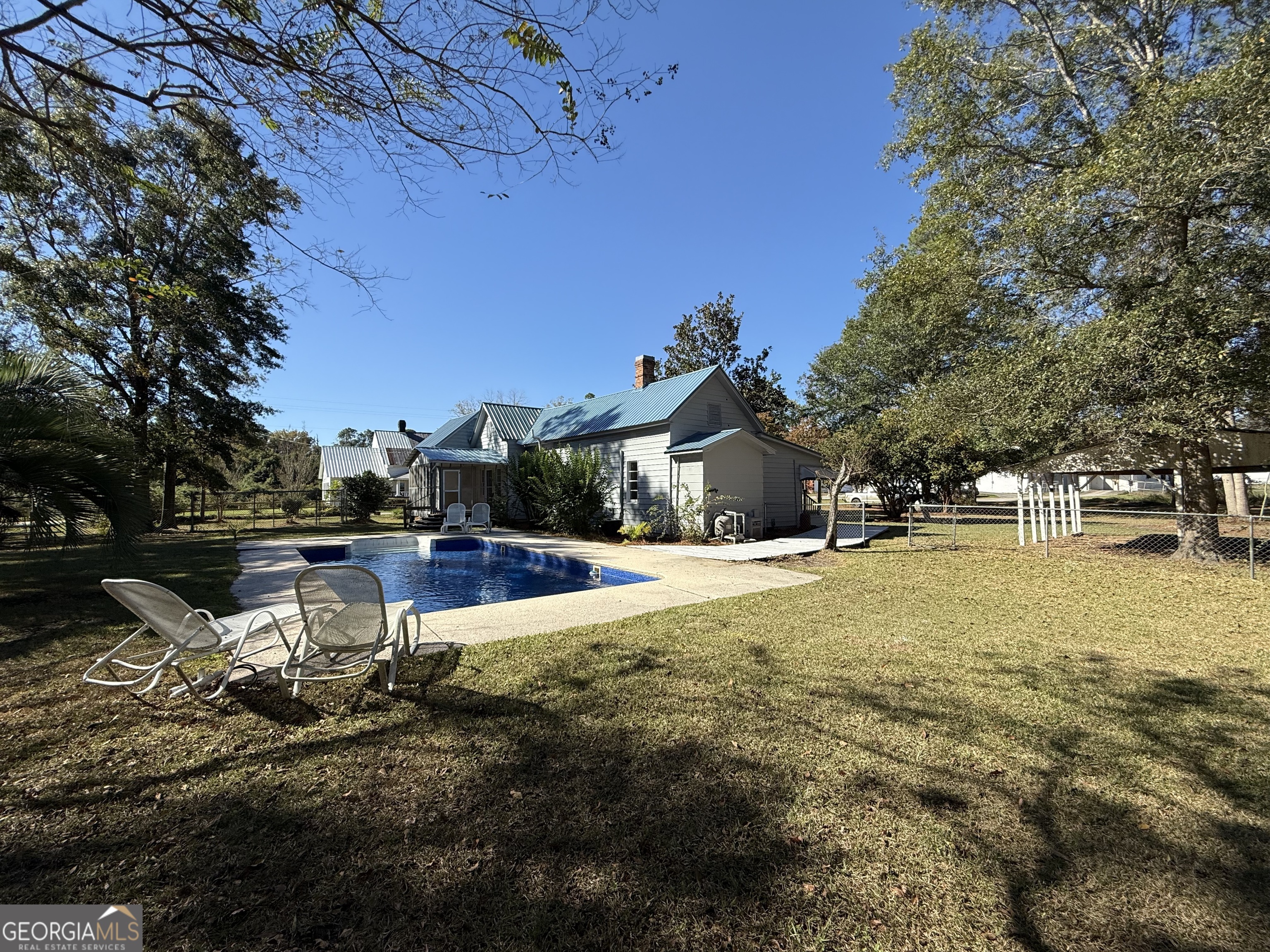 405 Monroe Street Garfield, GA 30425 - Photo 27 of 30 a swimming pool with outdoor seating and yard