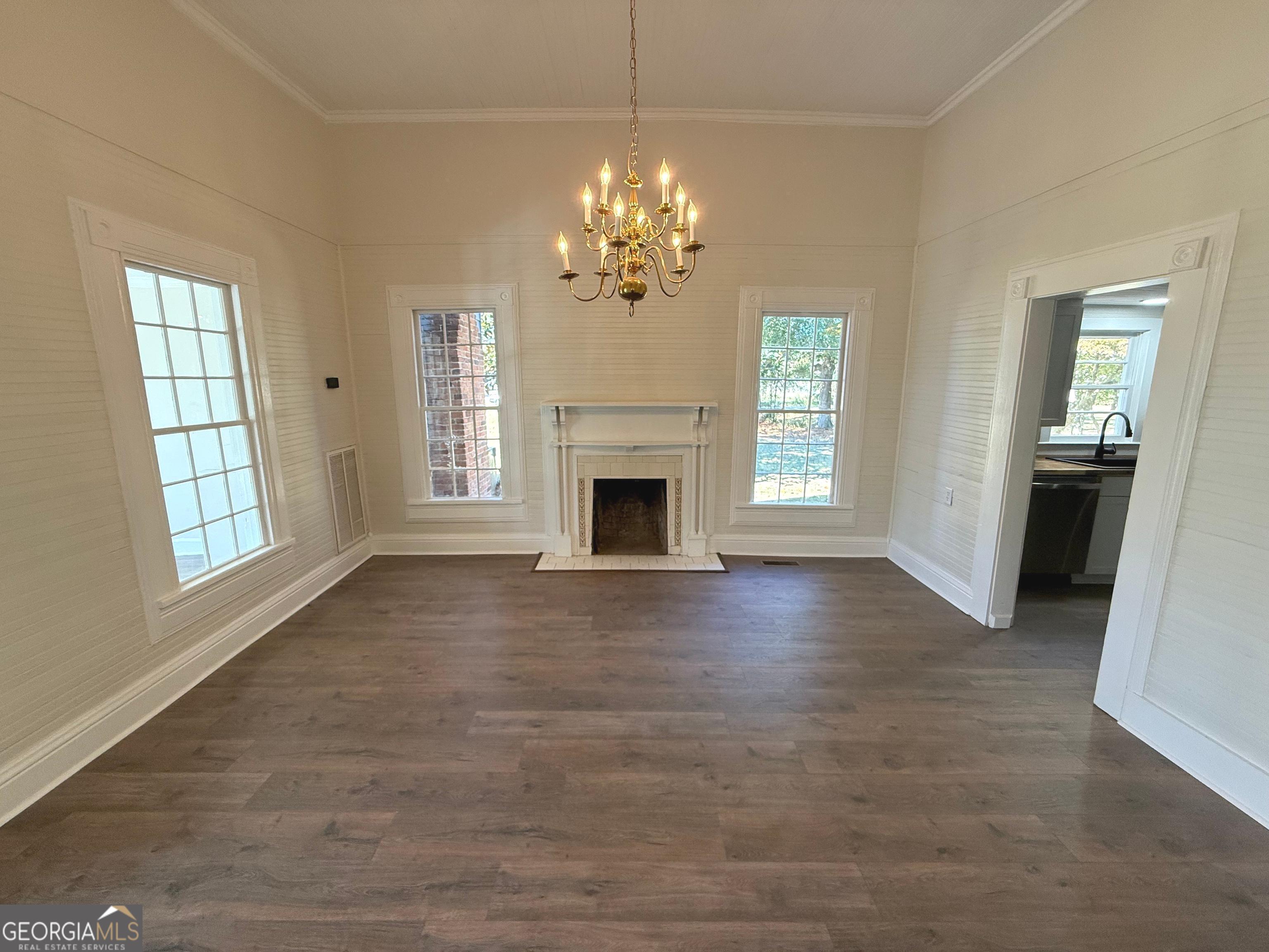 405 Monroe Street Garfield, GA 30425 - Photo 3 of 30 a view of an empty room with a fireplace and a window