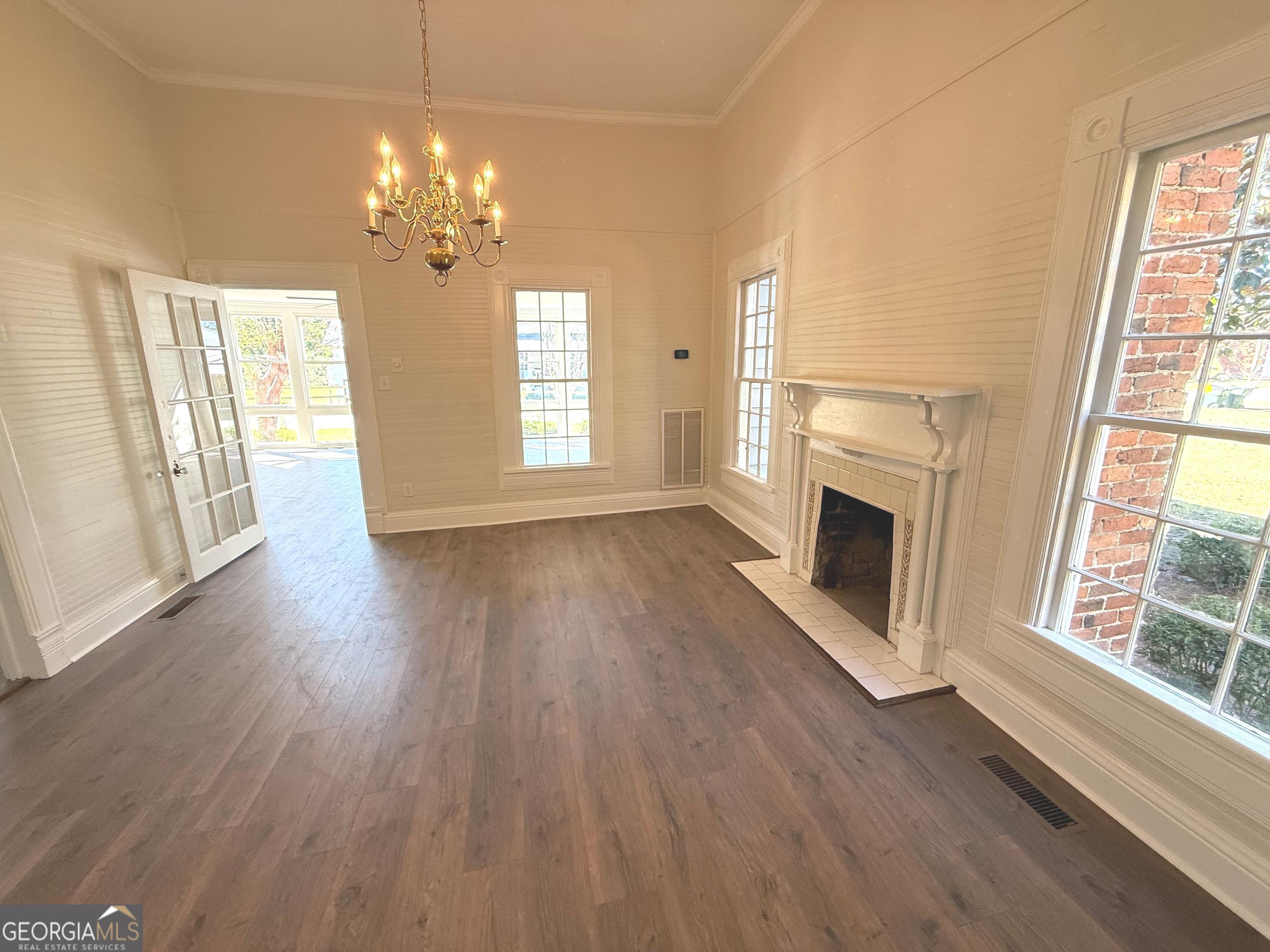 405 Monroe Street Garfield, GA 30425 - Photo 4 of 30 a view of a livingroom with wooden floor fireplace and windows