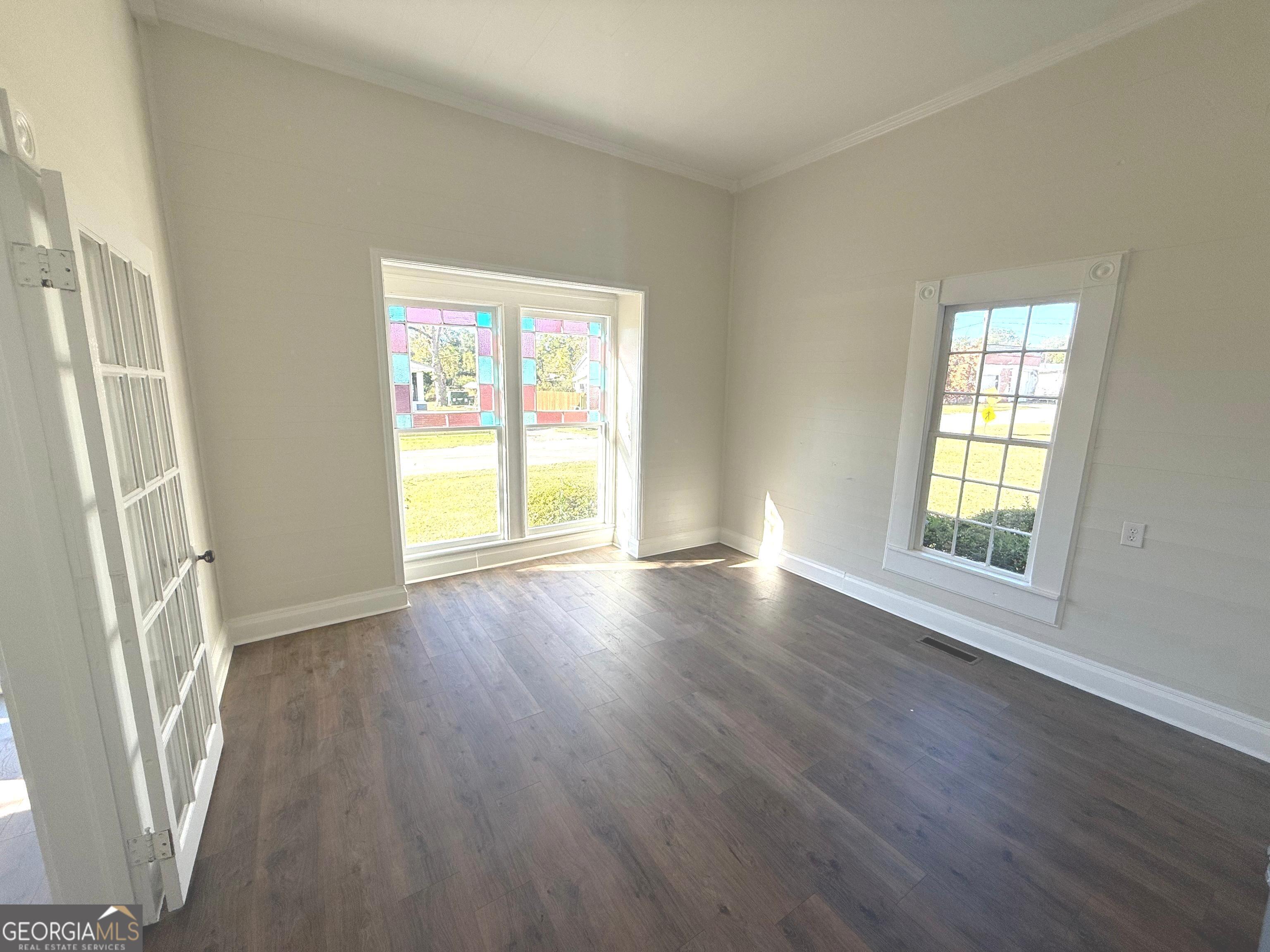 405 Monroe Street Garfield, GA 30425 - Photo 9 of 30 a view of livingroom with hardwood floor and window