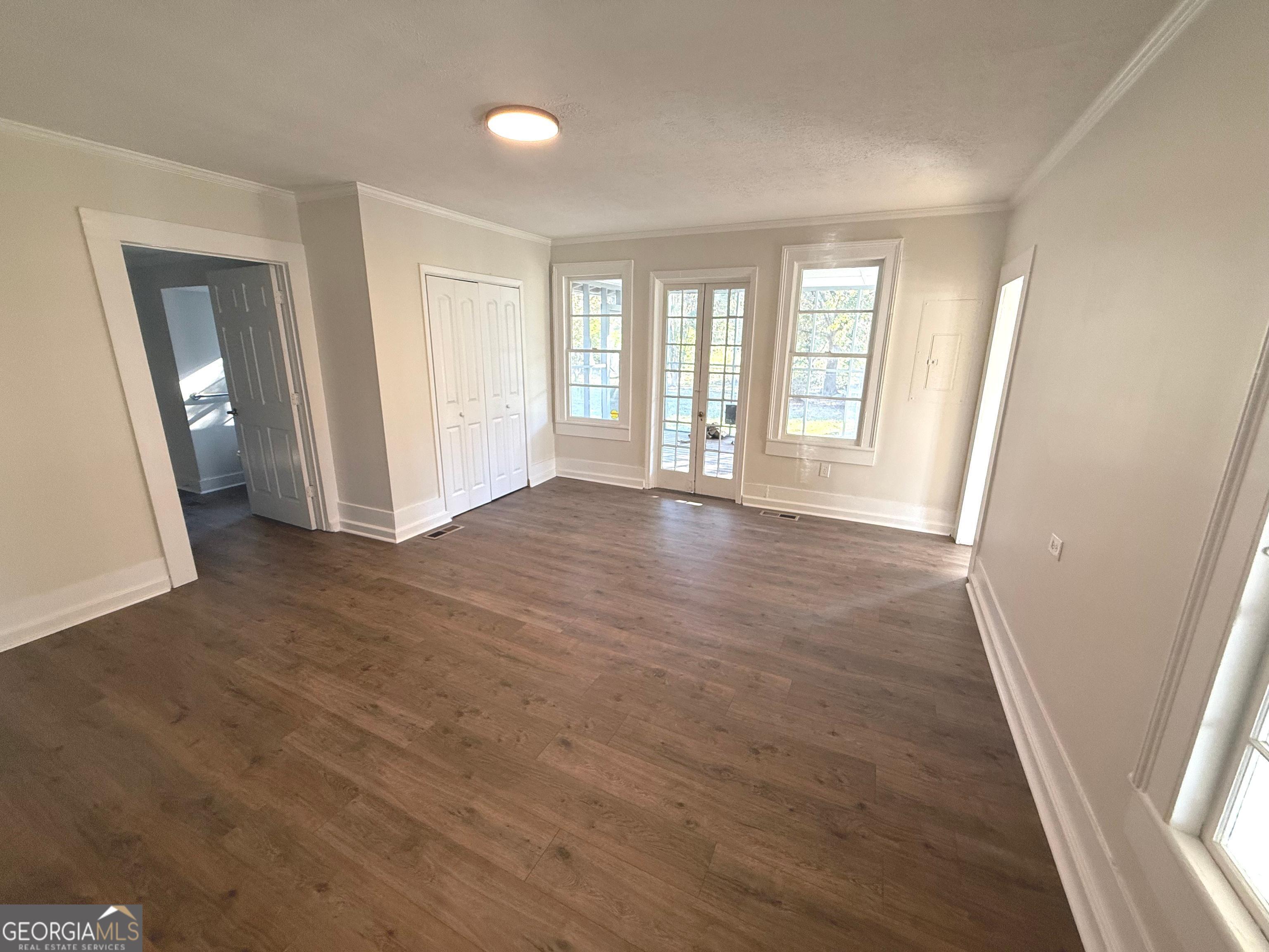 405 Monroe Street Garfield, GA 30425 - Photo 10 of 30 a view of empty room with wooden floor and fan