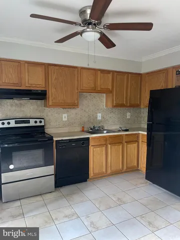a kitchen with a stove a sink and a refrigerator