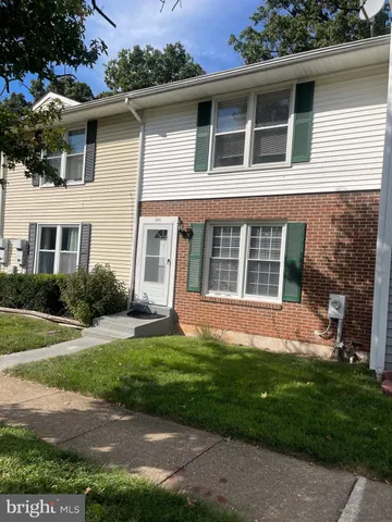 a view of a house with a yard and a garden