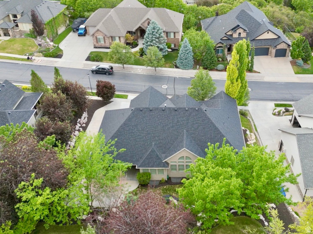577 South Ridge Top Lane East North Salt Lake, UT 84054 - Photo 54 of 57 The oversized lot extends into a lush backyard filled with mature shade trees, established landscaping, and natural rock accents, providing exceptional privacy and outdoor enjoyment.