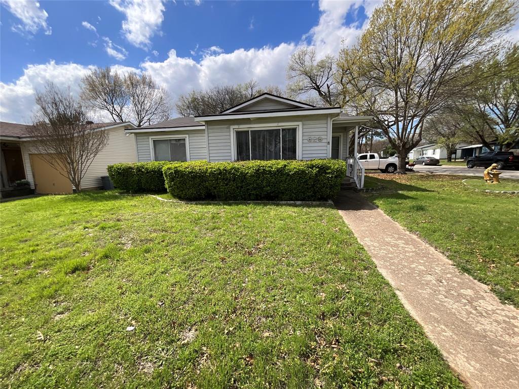 629 Harrison Lane Hurst, TX 76053 - Photo 1 of 20 a front view of a house with a yard and garage