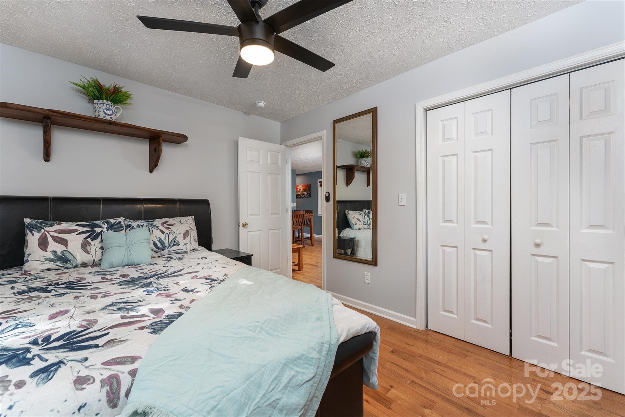 141 Willets Point Boulevard Nebo, NC 28761 - Photo 12 of 29 a bedroom with a large bed and a chandelier