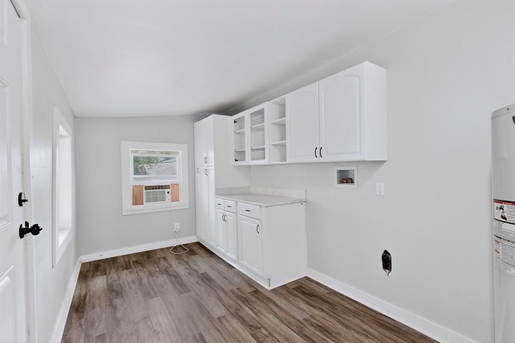 313 Farm To Market 316 Eustace, TX 75124 - Photo 20 of 33 a view of a kitchen with wooden floor and white cabinets