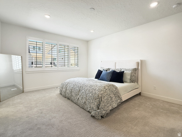 916 Rocky Mountain Way Elk Ridge, UT 84651 - Photo 20 of 54 Bedroom with carpet floors, recessed lighting, and a textured ceiling