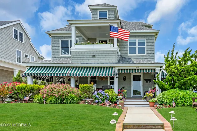 a front view of a house with a garden and plants