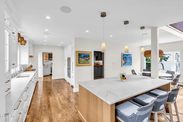 a kitchen with kitchen island granite countertop a stove and a sink