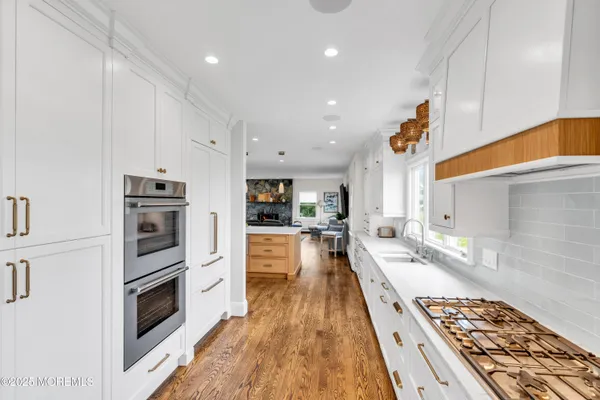 a large kitchen with a table and chairs in it