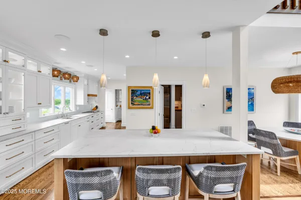 a kitchen with kitchen island granite countertop a stove and a sink