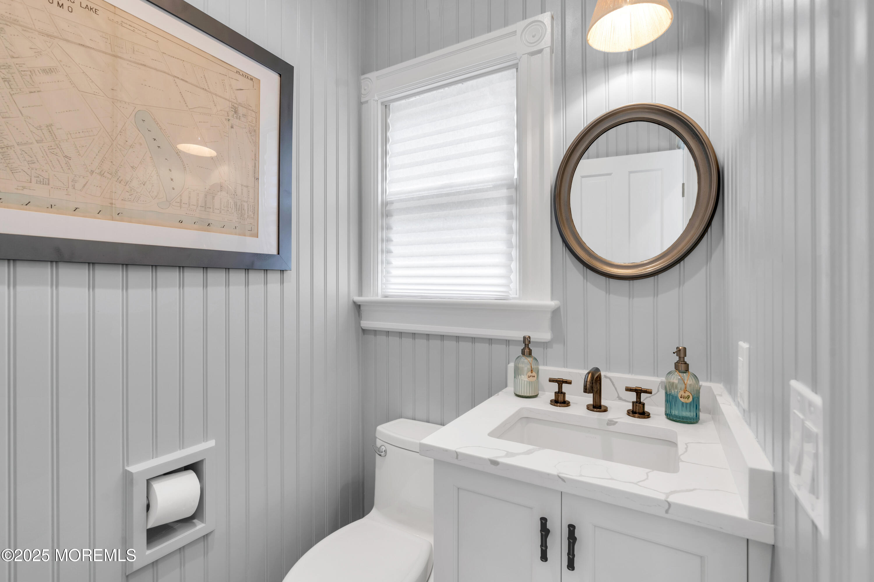 1612 Ocean Avenue Spring Lake, NJ 07762 - Photo 24 of 61 a bathroom with a toilet a sink and mirror