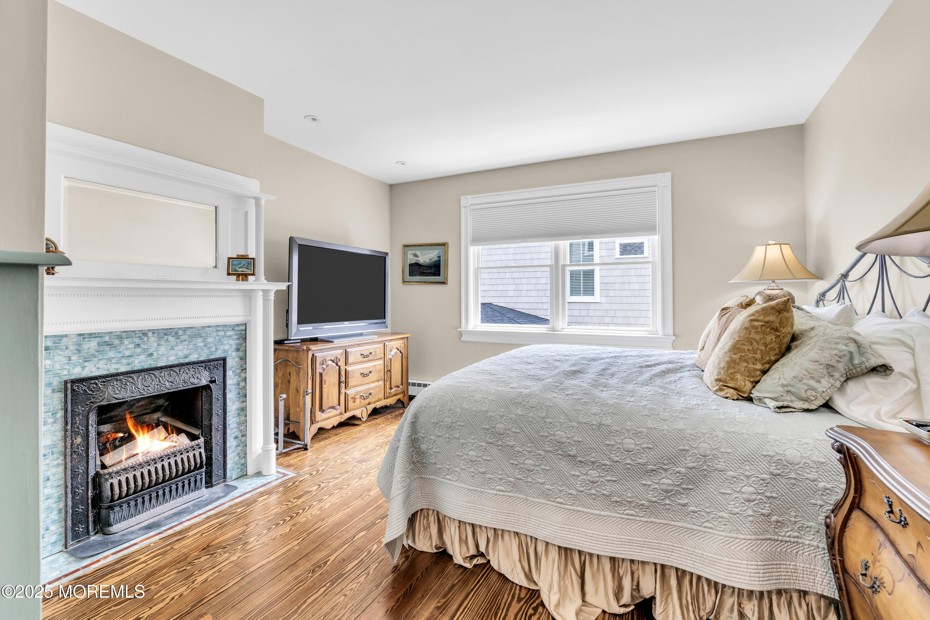 1612 Ocean Avenue Spring Lake, NJ 07762 - Photo 31 of 61 a bedroom with a bed and a fireplace