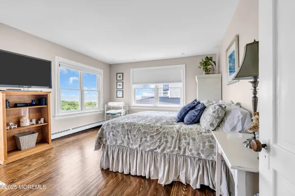 a bedroom with furniture and a wooden floor