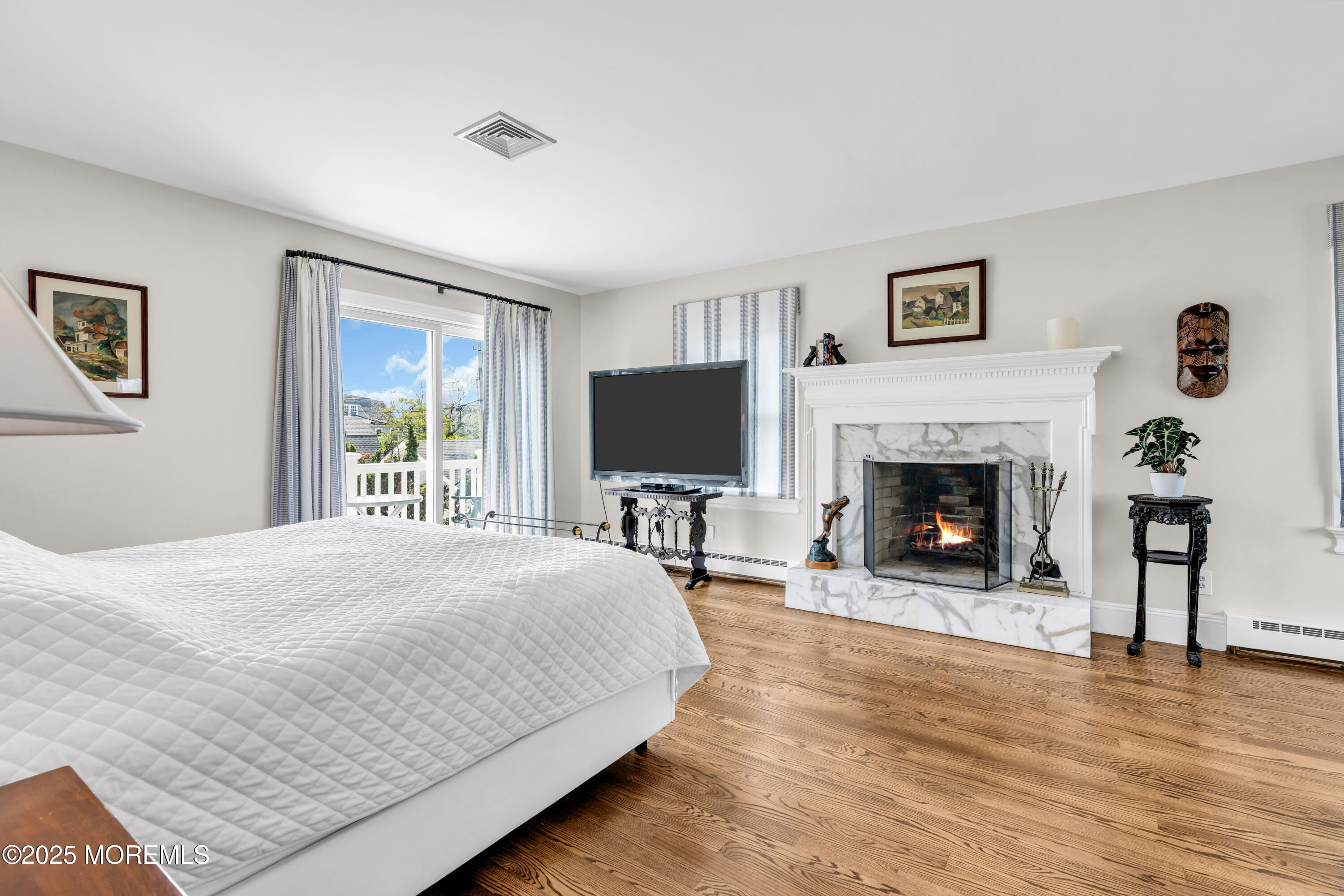 1612 Ocean Avenue Spring Lake, NJ 07762 - Photo 38 of 61 a bedroom with a bed and a fireplace