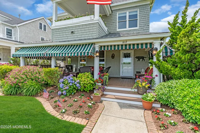 a bedroom with two beds and painting on the wall