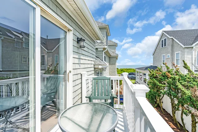 a view of a chair and table in backyard of the house