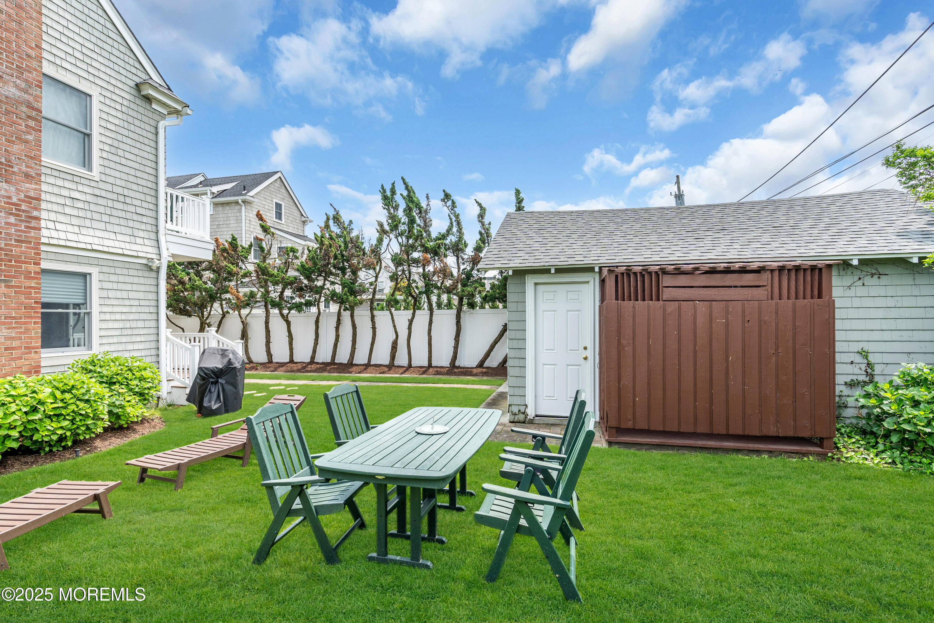 1612 Ocean Avenue Spring Lake, NJ 07762 - Photo 53 of 61 a view of a chair and table in backyard of the house