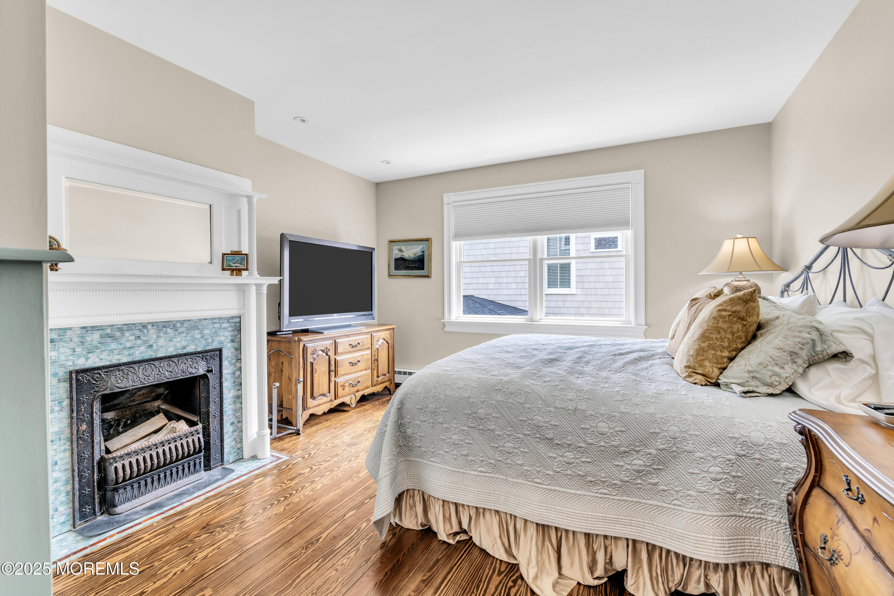1612 Ocean Avenue Spring Lake, NJ 07762 - Photo 60 of 61 a bedroom with a bed and a fireplace