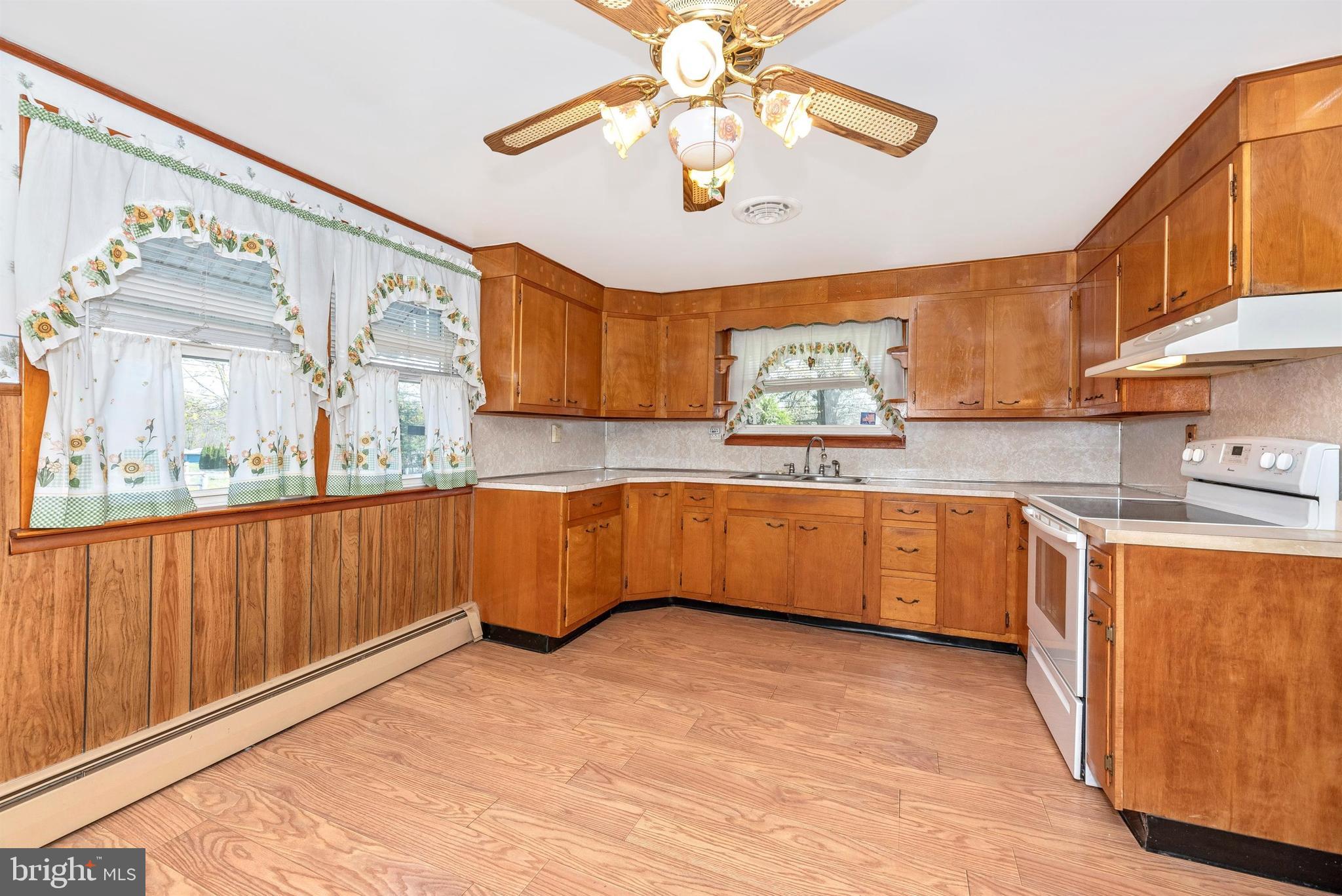 9250 Rocky Ridge Road Rocky Ridge, MD 21778 - Photo 12 of 67 a kitchen with granite countertop a stove a sink and a wooden cabinets
