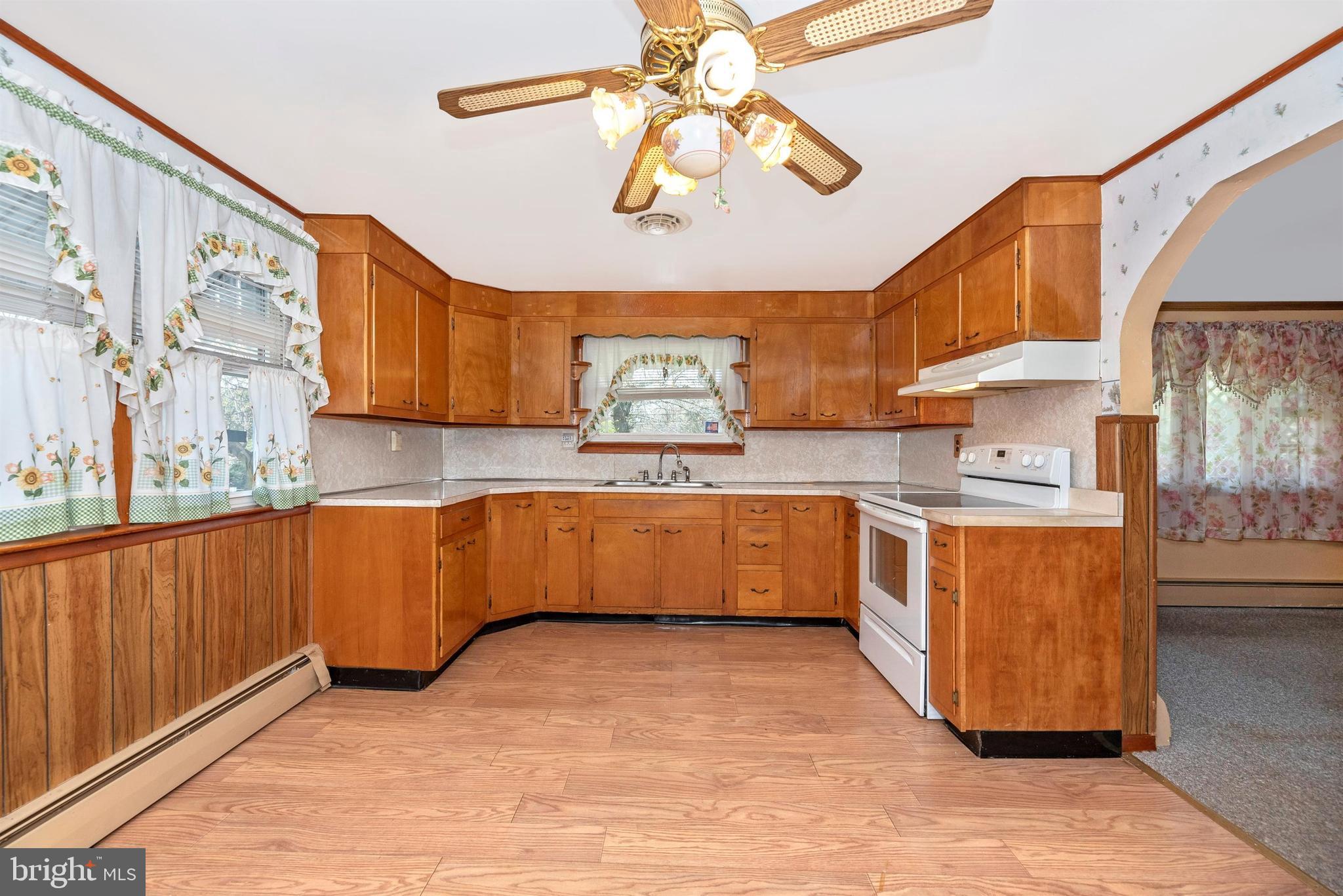 9250 Rocky Ridge Road Rocky Ridge, MD 21778 - Photo 13 of 67 a kitchen with stainless steel appliances granite countertop a sink cabinets and wooden floor